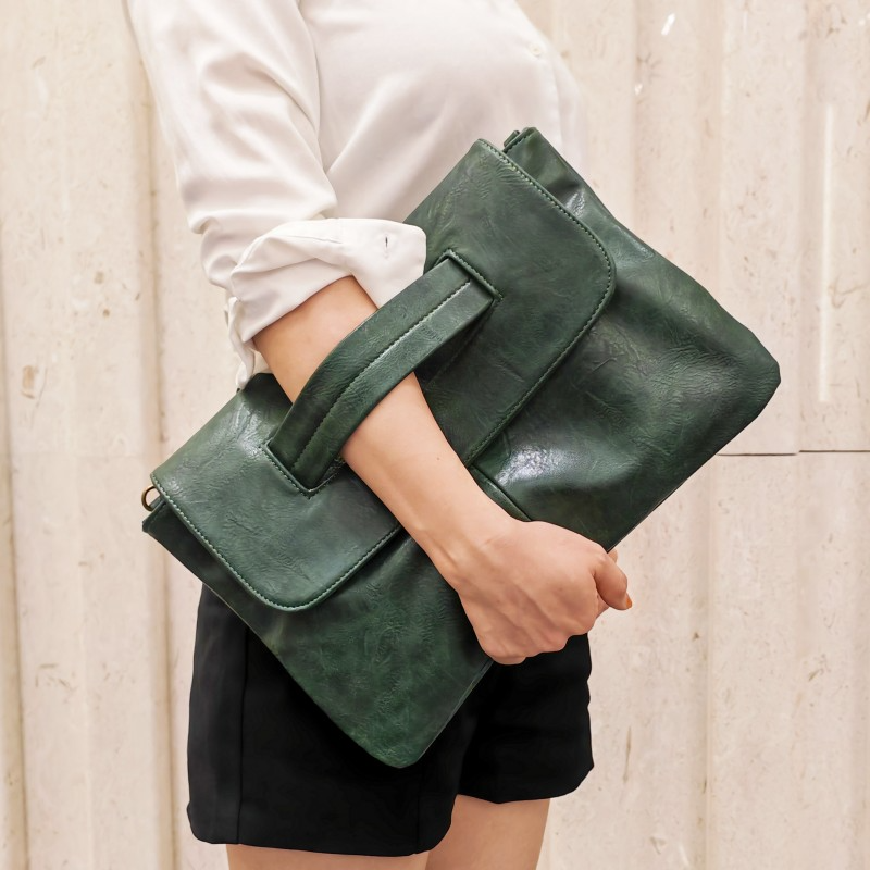 Chic women's vegan leather handbag styled with a minimalist outfit, emphasizing its modern and versatile appeal.