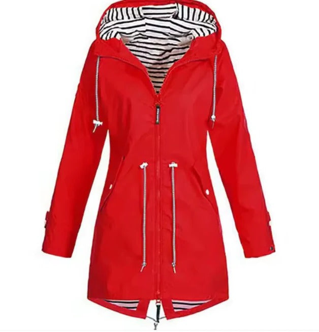 Woman enjoying a walk in a stylish waterproof hooded rain jacket, perfect for outdoor activities & everyday casual outings.