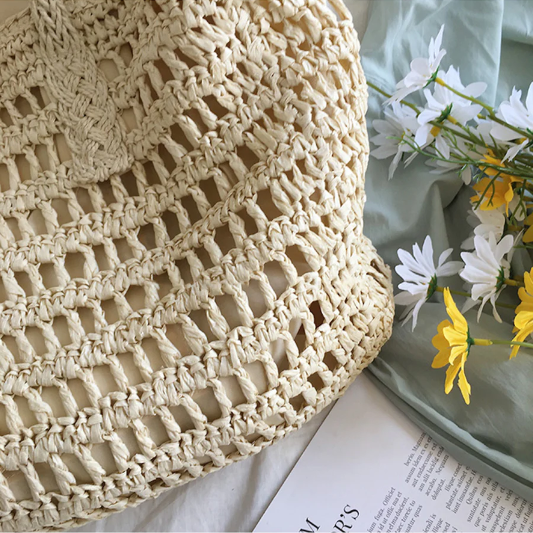Elegant white woven beach tote bag for women, a stylish accessory for sunny days.