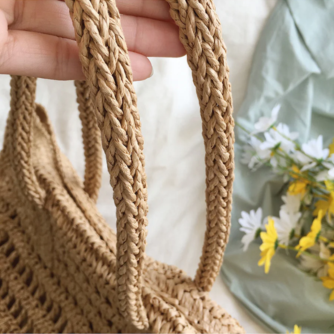 Women's summer woven beach tote, stylish & practical for seaside trips & casual wear.
