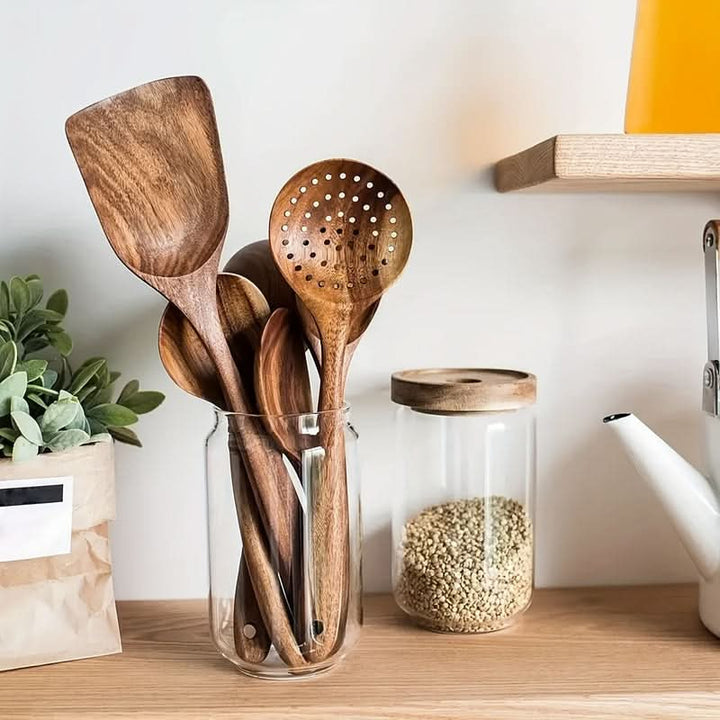 Eco-friendly teak wood cooking utensils. Includes spatula, spoon, and turner for sustainable kitchen use.