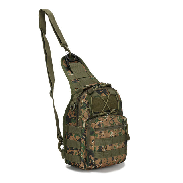 Outdoor shot of a black tactical sling backpack lying on the ground, suitable for camping gear.