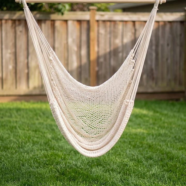 Outdoor tasseled swing chair, perfect for garden and patio relaxation; a chic bohemian hanging seat.