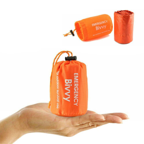 Thermal bivy emergency sleeping bag unfolded, showing reflective interior for outdoor survival.