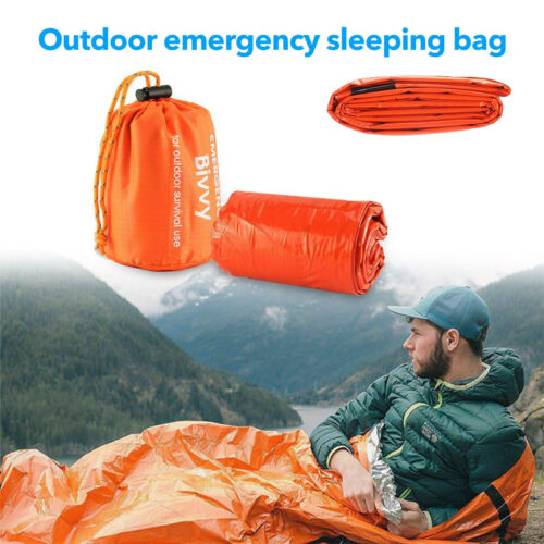 Hands holding a rolled-up lightweight thermal bivy, emphasizing its portability for hiking.