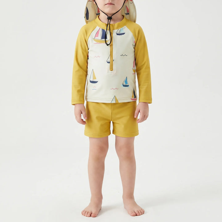 Children's long-sleeve swim set with matching shorts and sun protection hat. Ideal toddler swimwear for summer fun.