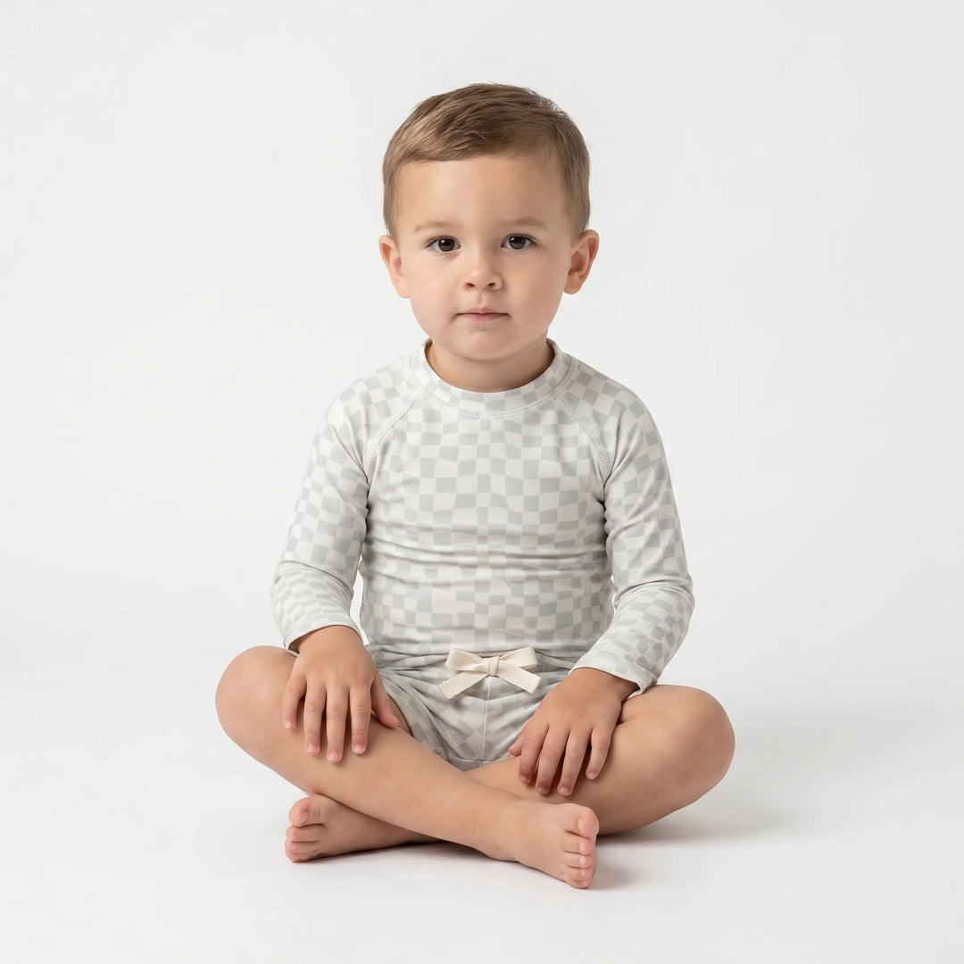 Stylish kids' two-piece long sleeve rash guard swim set, perfect for summer beach & pool days.