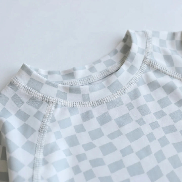 Vibrant toddler long sleeve rash guard and swim shorts set, ideal for sun-safe play.