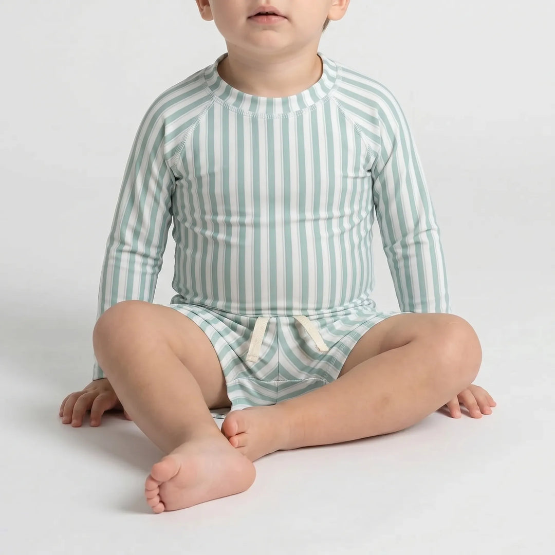 Long sleeve rash guard top and matching swim shorts for toddlers, offering full sun protection.