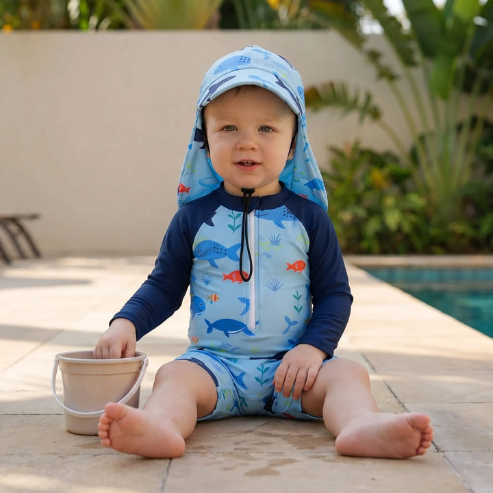 Sun protective toddler rash guard swim romper. Stylish long sleeve baby beach outfit for summer fashion.