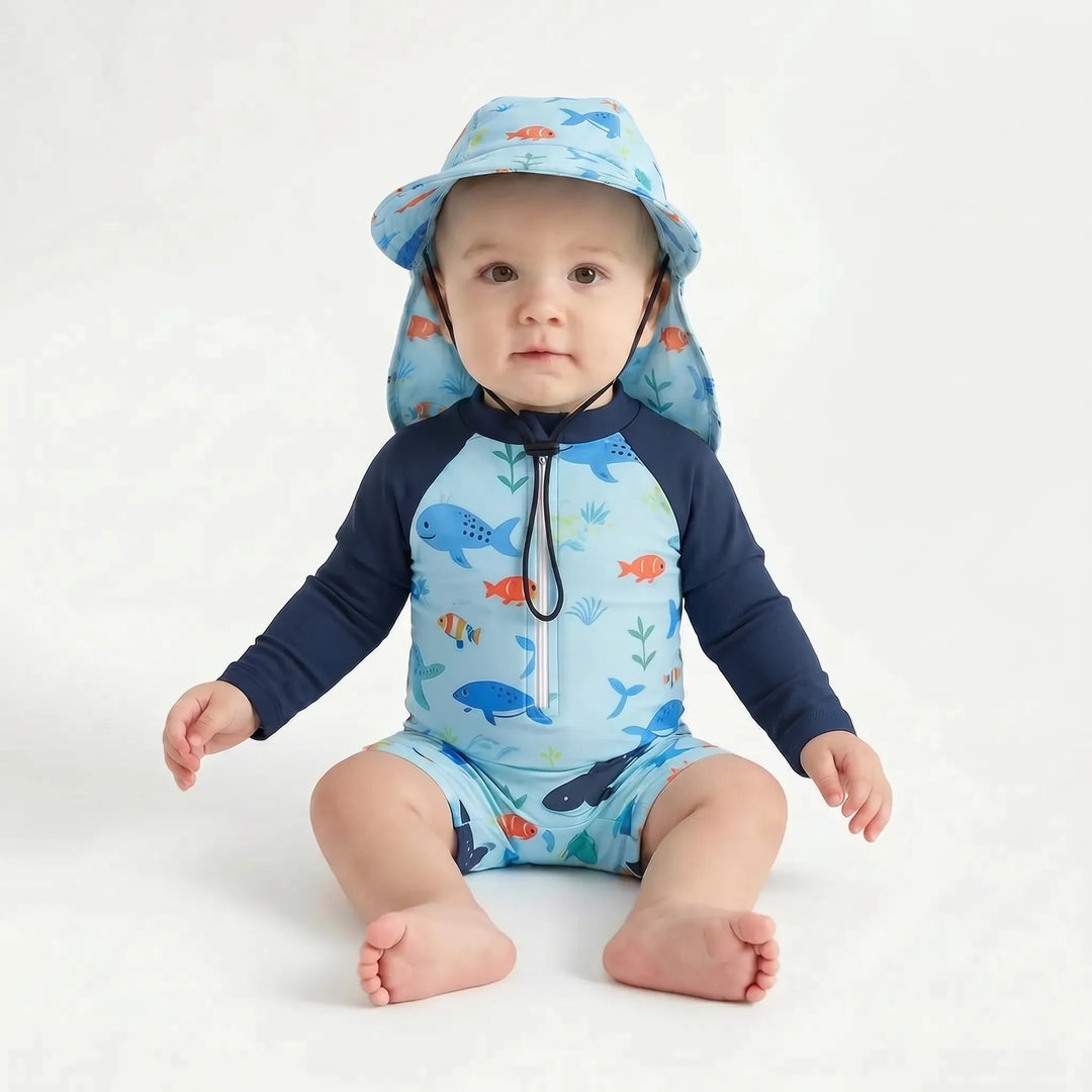 UPF 50+ long sleeve toddler swim romper. Sun protective baby rash guard for beach, water play & summer fashion.