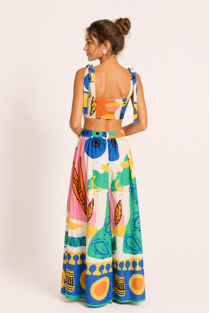 Flowy tropical print crop top & maxi skirt set. Sleeveless two-piece resort wear for women's summer fashion.