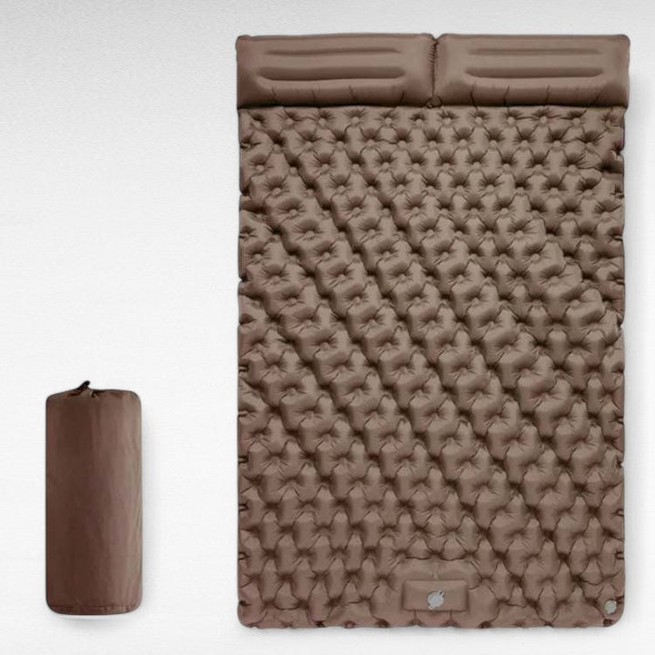 Overall shot of the inflated two-person sleeping pad, ready for use in a natural outdoor setting.