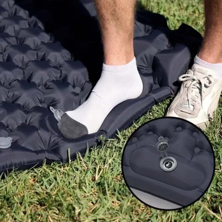 Detail of built-in foot pump on inflatable camping sleeping pad, demonstrating fast inflation.