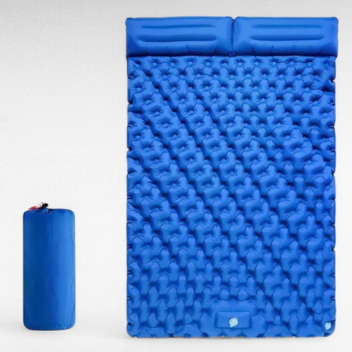 Two-person camping sleeping pad next to a tent, emphasizing outdoor adventure readiness.