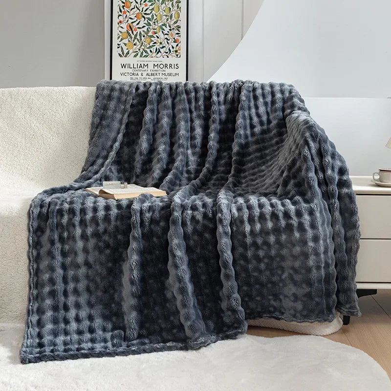 Stylish & warm fleece throw blanket with bubble texture, enhancing living room & bedroom home decor.