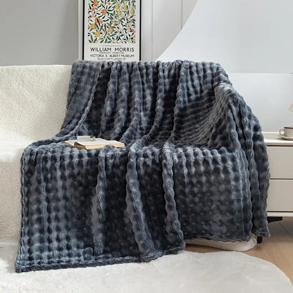 Stylish & warm fleece throw blanket with bubble texture, enhancing living room & bedroom home decor.