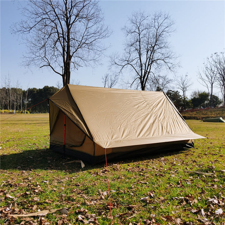 Solo A-frame tent, freestanding with trekking poles, on a rocky terrain.