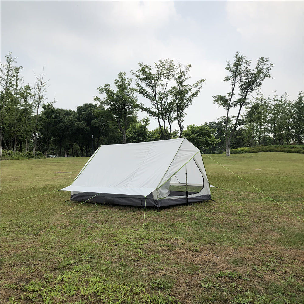 Duo ultralight trekking tent with two people inside, illuminated.