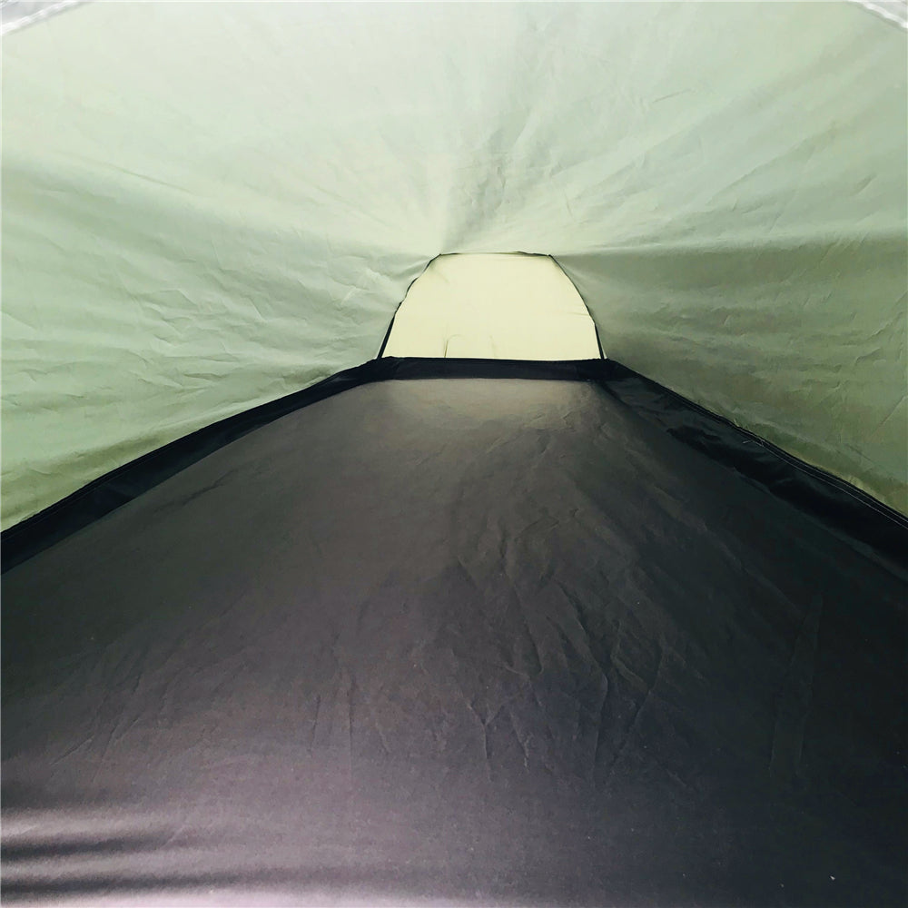 Ultralight green bivy tent with all zippers closed, ready for foul weather.
