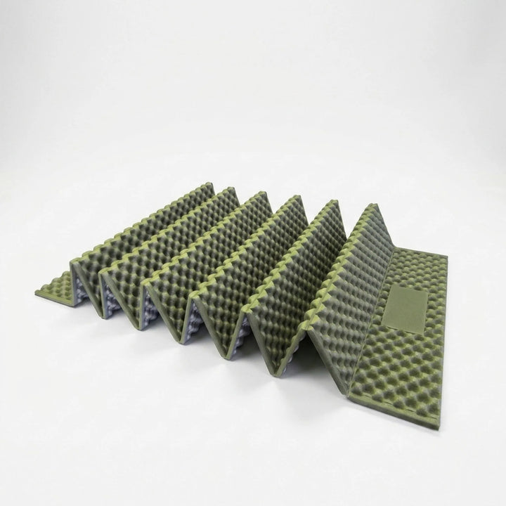 Unrolled gray ultralight camping mat. Essential insulated sleeping pad for outdoor backpacking & hiking gear.