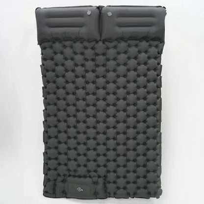 Camping essentials laid out, including the ultralight inflatable mattress and other gear.