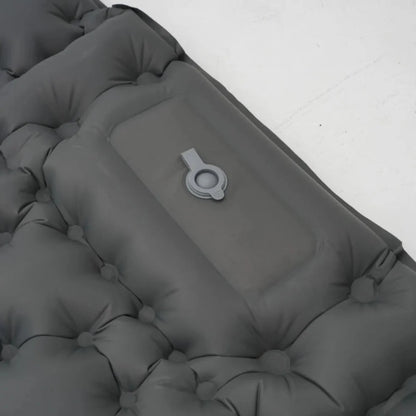Foot actively pumping an ultralight inflatable mattress, quick inflation process.