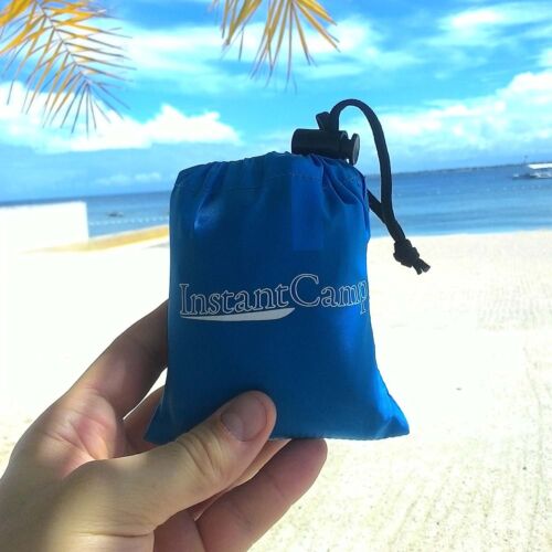 Travel pillow, gray, deflated, rolled up tightly, highlighting its easy portability