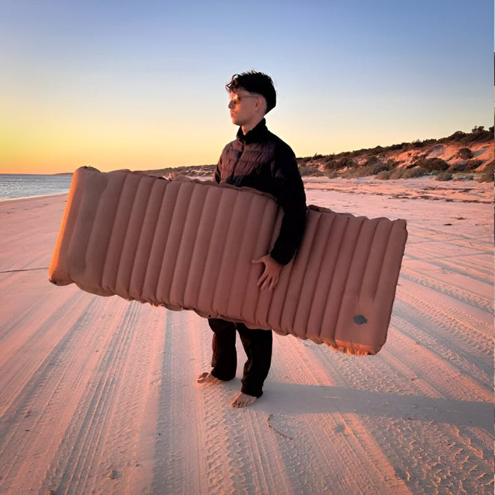 Ultralight inflatable camping sleeping pad with foot pump, ideal for hiking and outdoors.
