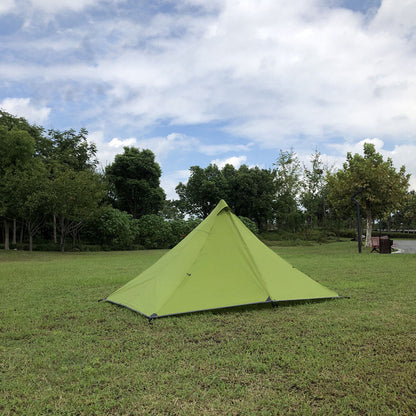Pyramid trekking pole tent with a backpack next to it, indicating its backpacking utility.