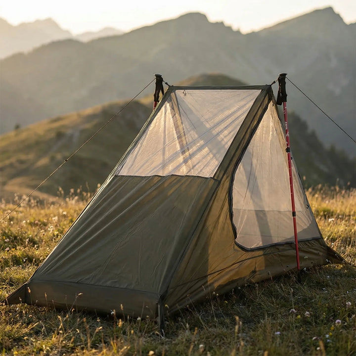 Ultralight single-person mesh tent set up using trekking poles, perfect for backpacking & hiking.