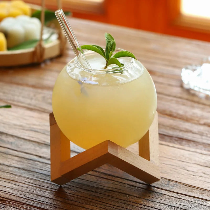 Unique glass Moon Ball Drink Tumbler with round shape, perfect for a modern home bar or kitchen beverage.