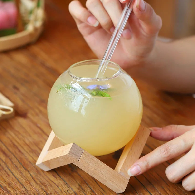 Modern glass Moon Ball Tumbler with a stylish wood base, ideal unique drinkware for gifts or home entertaining.