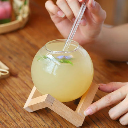 Modern glass Moon Ball Tumbler with a stylish wood base, ideal unique drinkware for gifts or home entertaining.