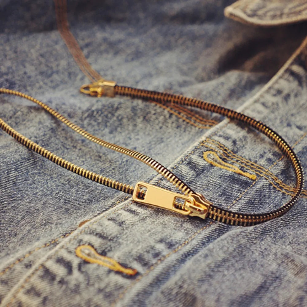 Statement women's necklace with a distinctive zipper design, elegant gold-plated fashion jewelry accessory.