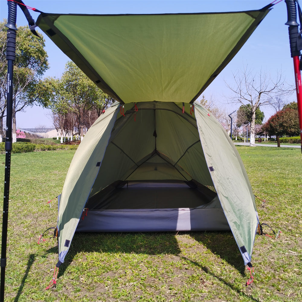 2-3 person expedition camping tent pitched near a lake, emphasizing its scenic use.
