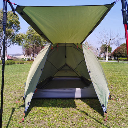 2-3 person expedition camping tent pitched near a lake, emphasizing its scenic use.