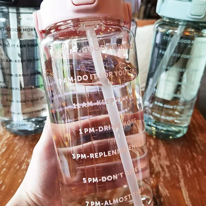 Large capacity 2L water bottle with straw and time markers, essential for fitness enthusiasts.