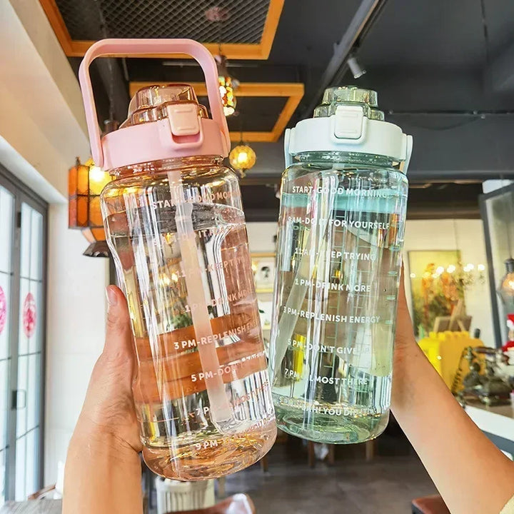 Sleek 2-liter water bottle, unisex design, with straw and clear time markers for hydration tracking.