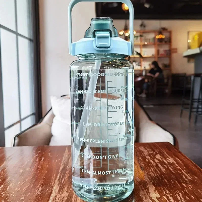 Daily hydration companion: 2L portable bottle, straw, and time markers for a healthy lifestyle.