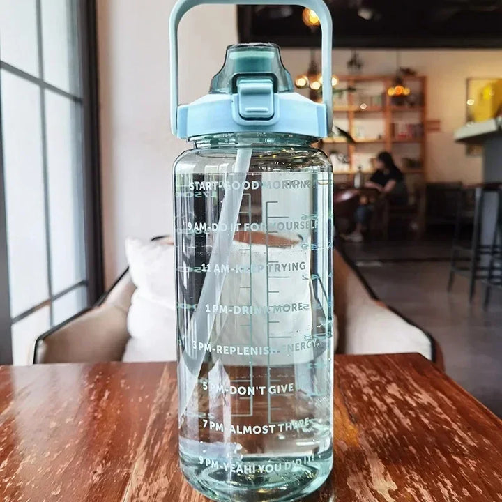 Daily hydration companion: 2L portable bottle, straw, and time markers for a healthy lifestyle.