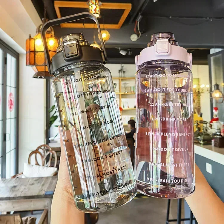 Large 2-liter sports water bottle, portable, with straw and motivational time markers.