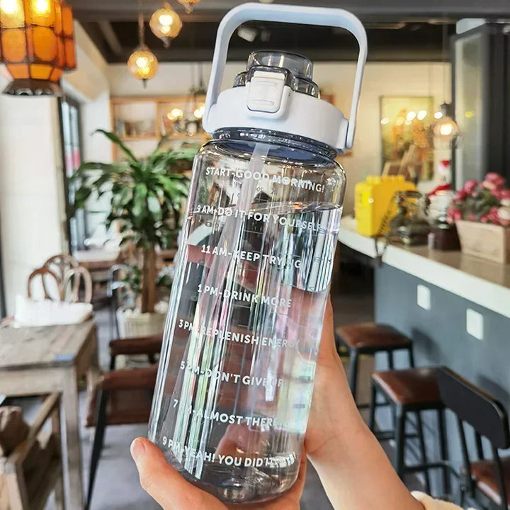Stay hydrated with this 2L water bottle, features straw, time markers, and portable design.