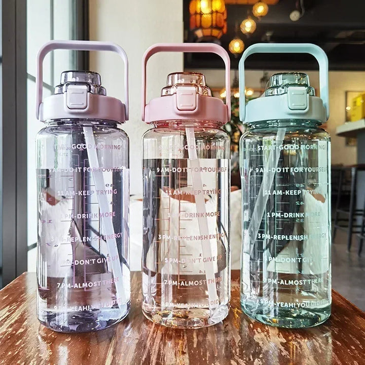 Durable 2L portable water bottle, unisex, with straw and time reminders for daily water intake.