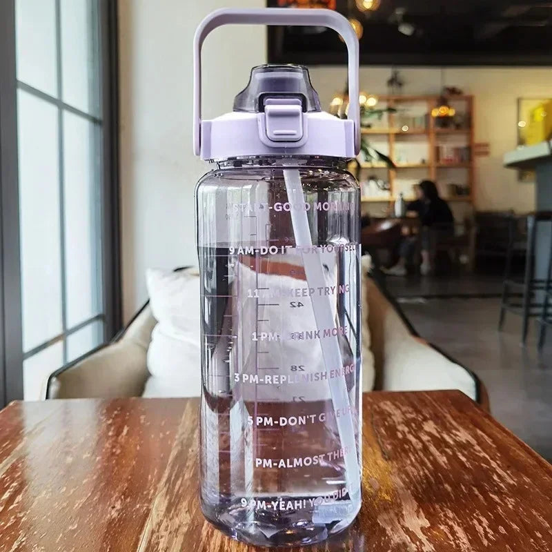 Sports & fitness 2L water bottle, includes straw and hourly time markers for hydration goals.