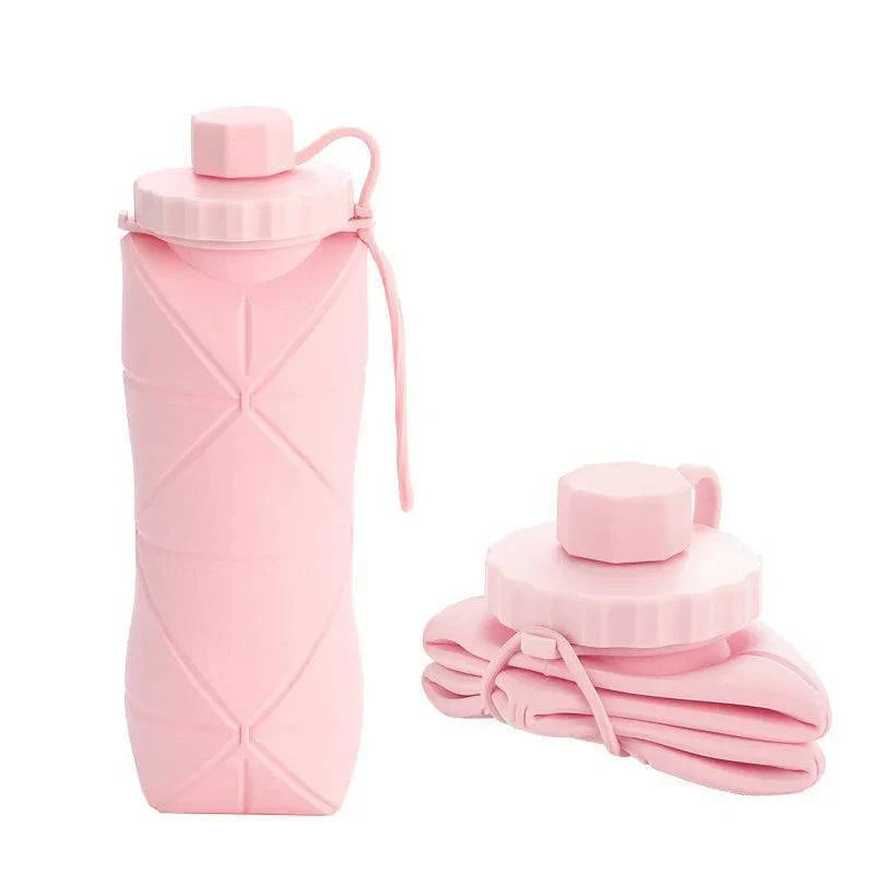 600ml silicone water bottle, shown next to a hand for scale, highlighting its comfortable grip and portability.