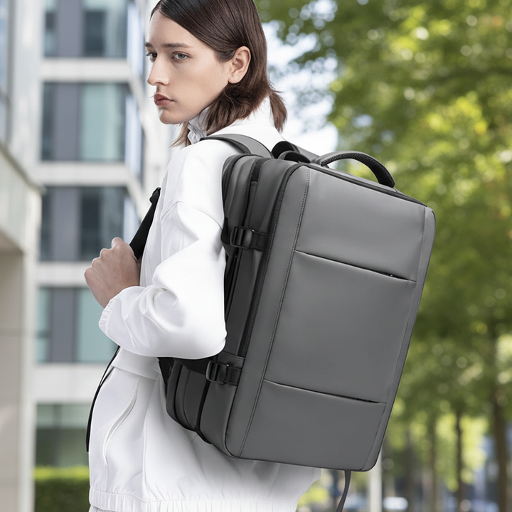 Expandable tech backpack for work or travel, featuring a dedicated laptop compartment & large capacity.