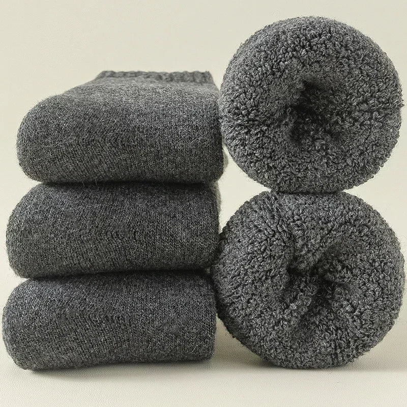 Folded unisex Alpine cozy socks in a 3-pack, ready for cold weather. Warm, breathable & moisture-wicking.