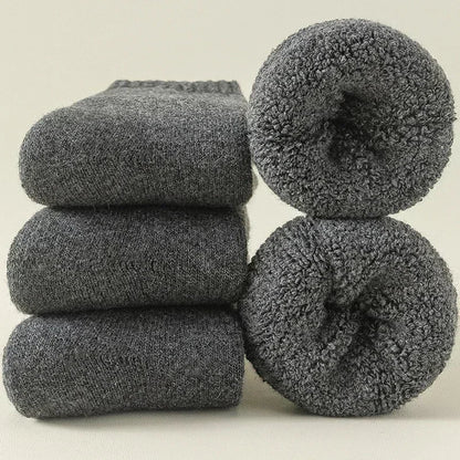 Folded unisex Alpine cozy socks in a 3-pack, ready for cold weather. Warm, breathable & moisture-wicking.