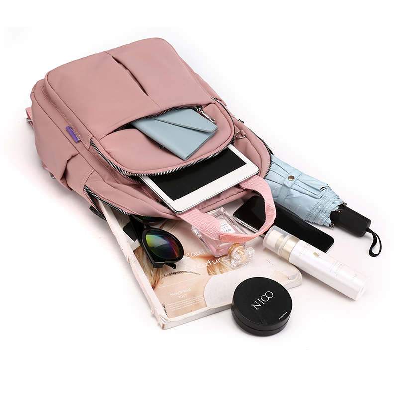 Versatile unisex daily backpack, anti-theft & water-resistant, with USB port for charging devices.